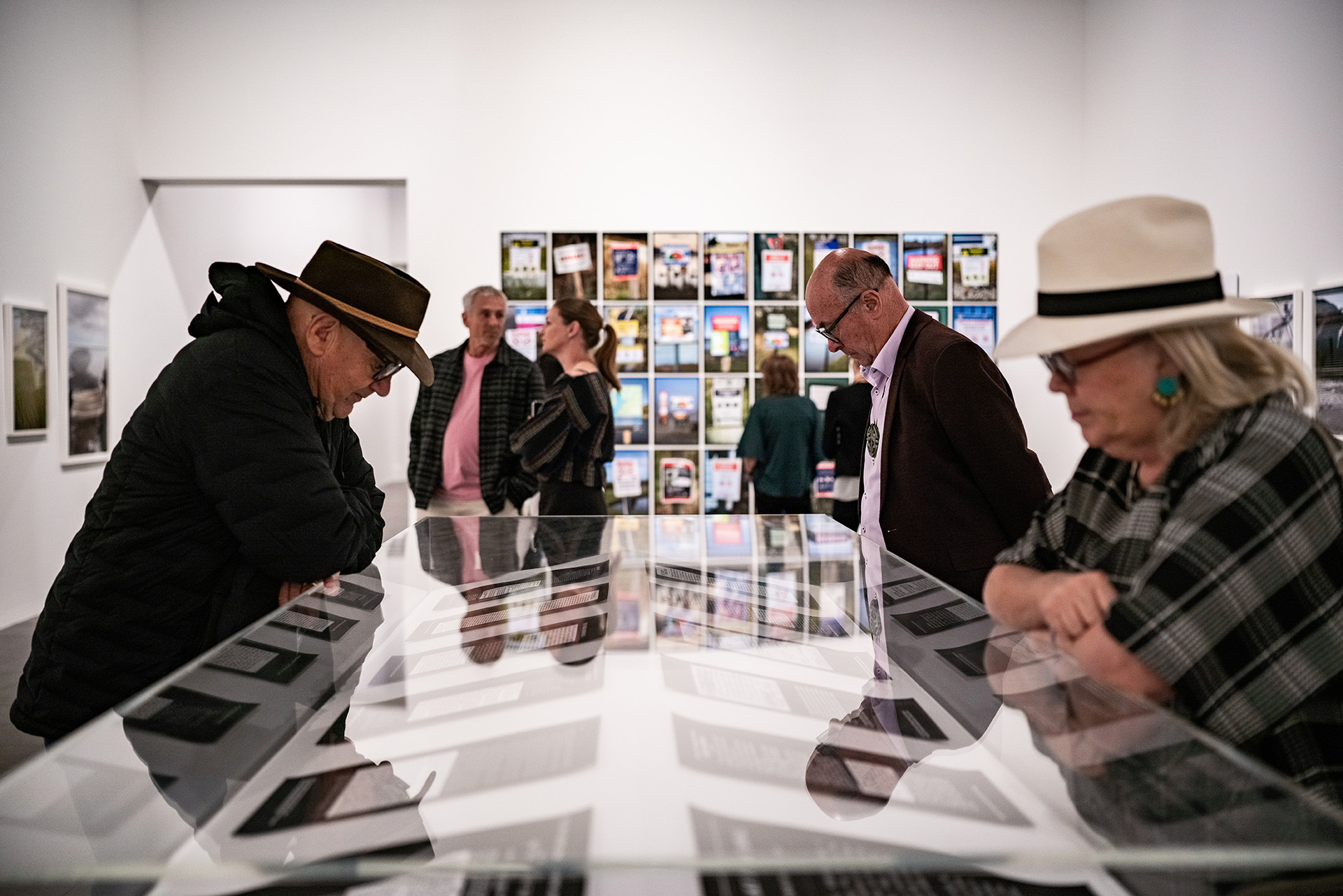 People looking at display case in gallery